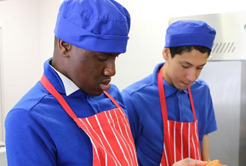 Two students in kitchen attire