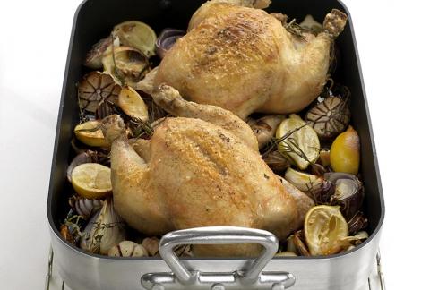 A tray of roast chicken with vegetables