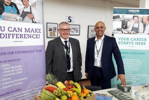 Two men at career event stall