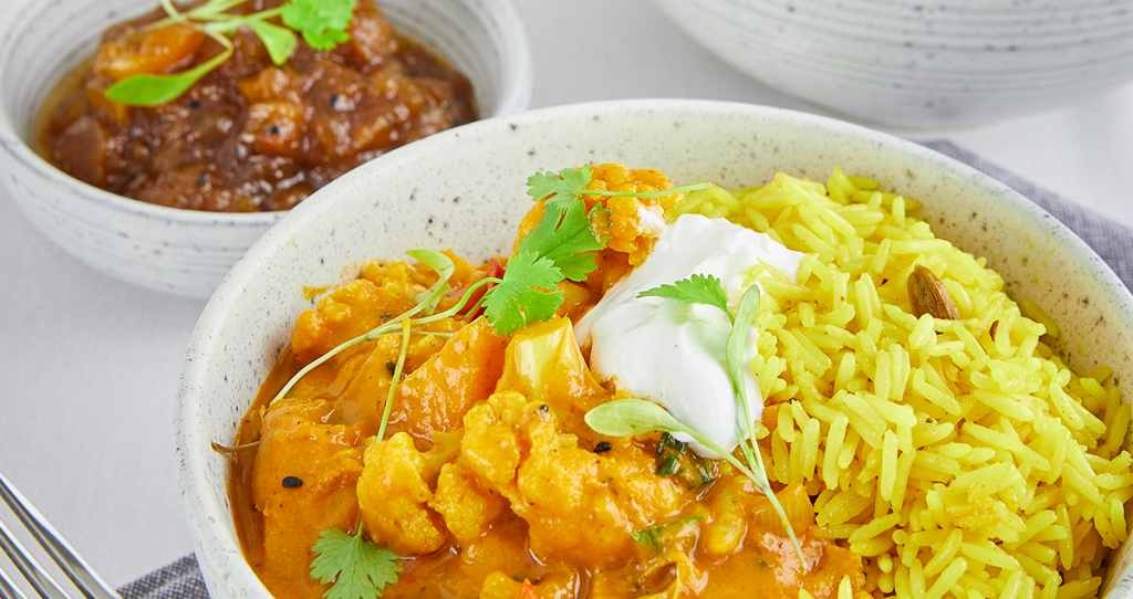 a dish of cauliflower Indian curry with basmati rice
