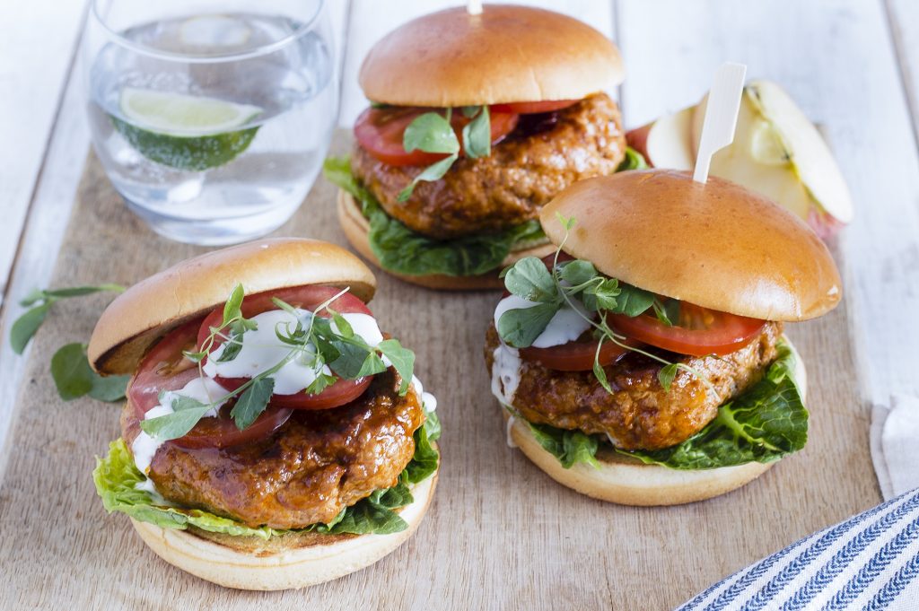 A platter with three Pork, apple, and mozzarella burgers