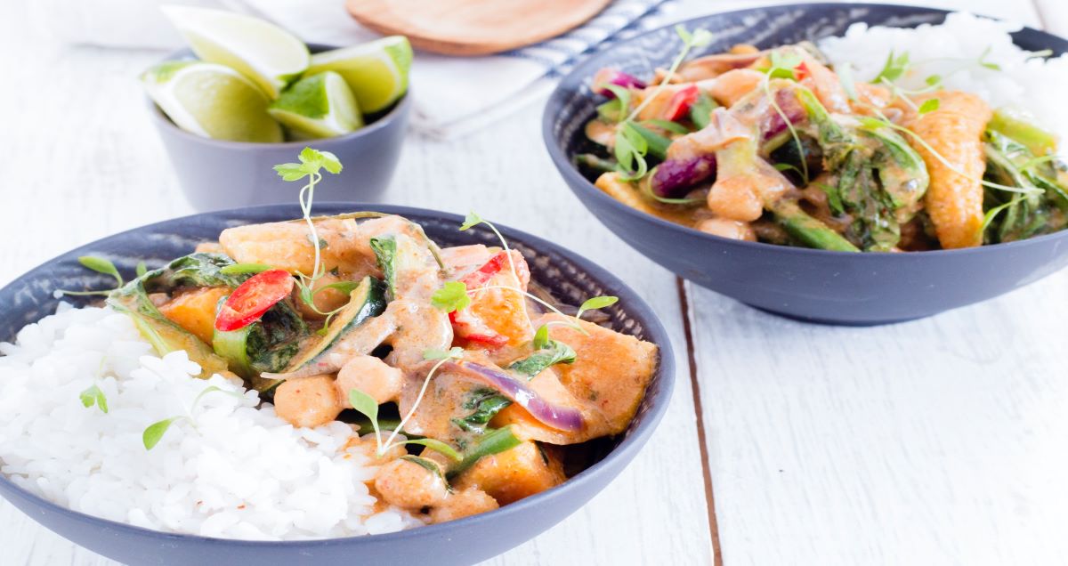 Two bowls of Sweet potato, chickpea, and coconut milk curry with rice