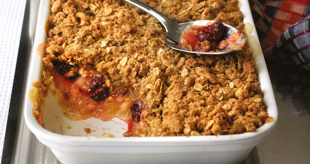 A tray of frashly baked apple and blackberry oaty crumble