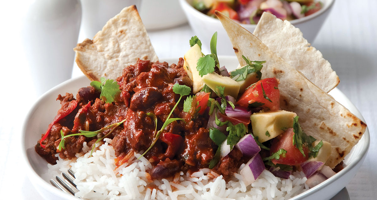 a bowl of Chili con carne with salsa salad