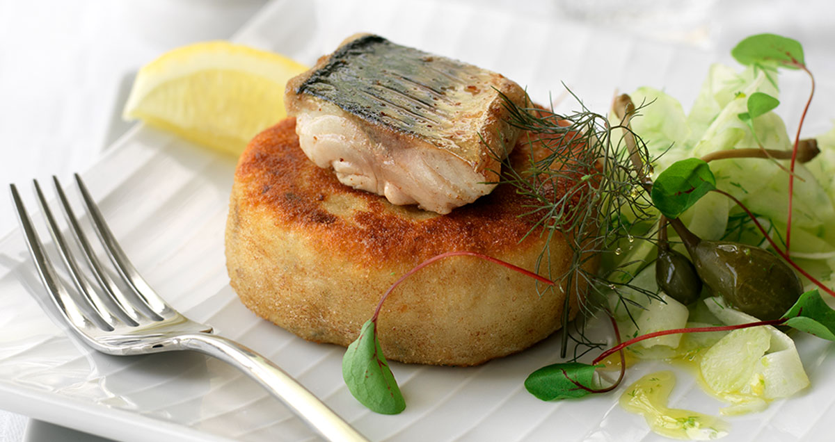 A plate with pollock fishcake with seared mackerel