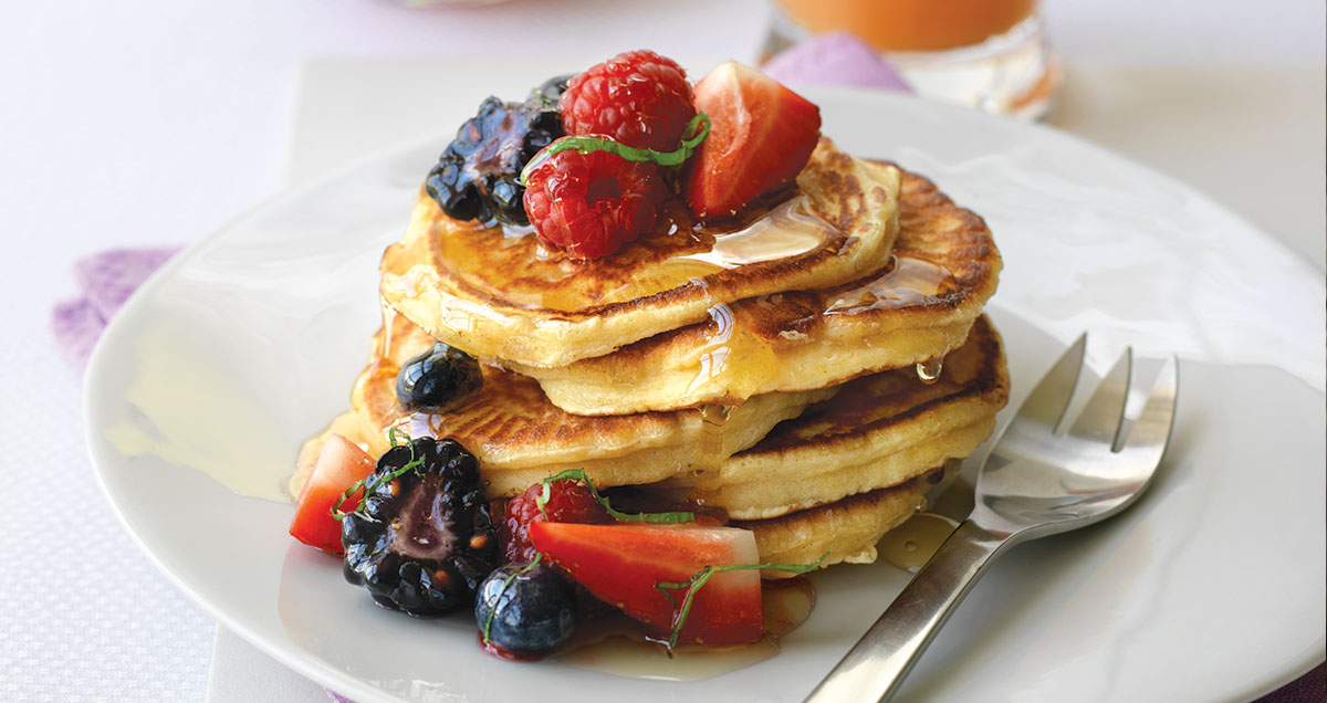 A stack of pancakes with summer berries