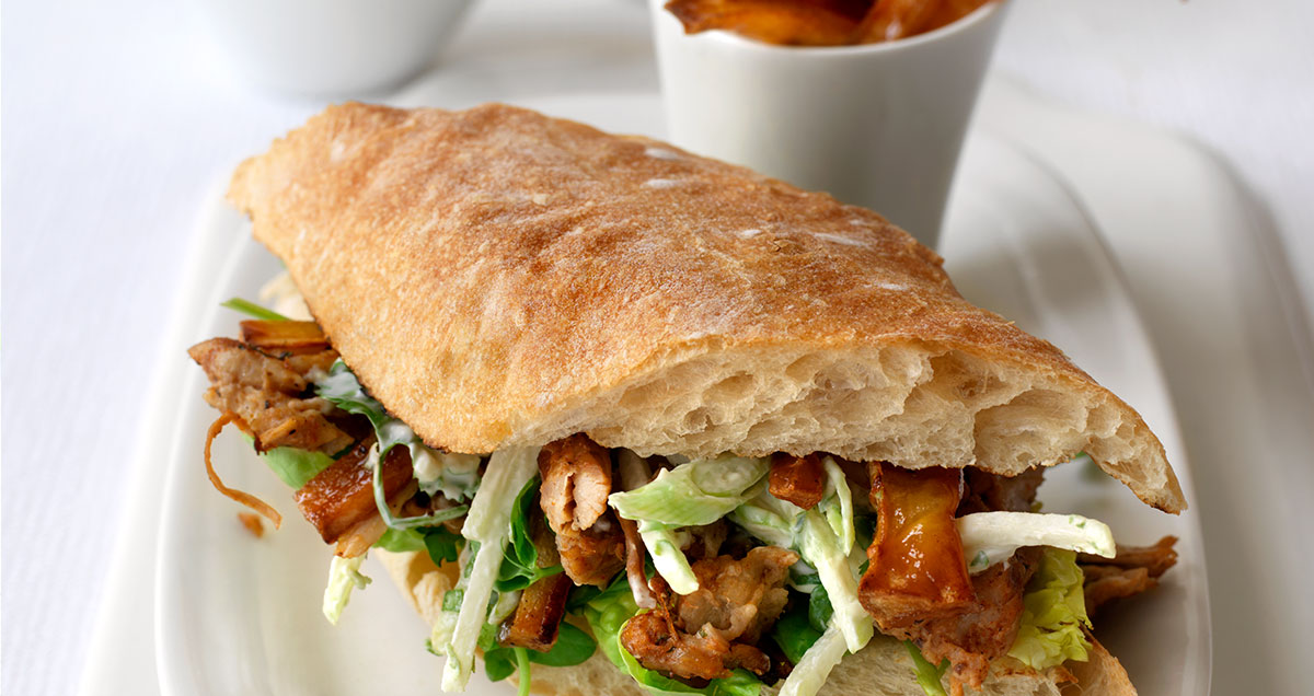 Pulled pork in ciabatta with sesame roasted parsnips