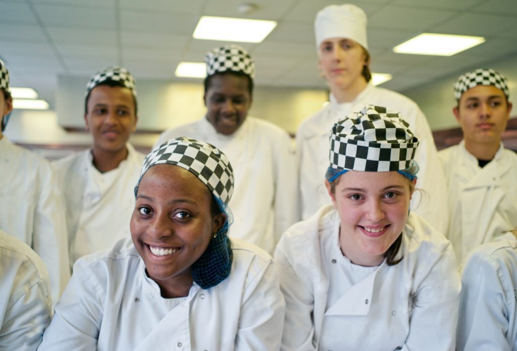 group of chefs in uniform, smiling