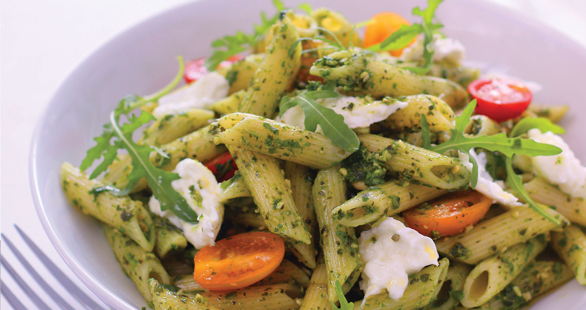 A dish of Penne Pasta, Cherry Tomato, and Roquette Pesto