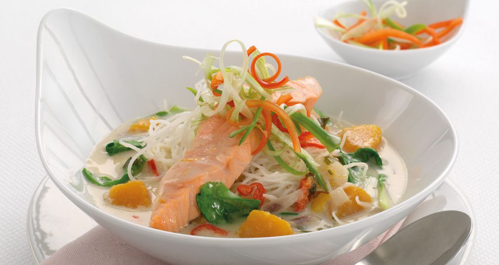 A bowl of Thai salmon and glass noodle laksa